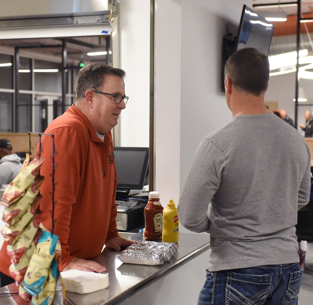 Recreation specialist Steve Evers runs the concession booth and talks with Brian Higginbotham after a dedication ceremony for the new Columbia Sports Fieldhouse Thursday